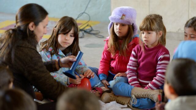 Die erste Klasse mit Lehrerin Synthia behandelt den menschlichen Körper - in eine selbst erstellte Schablone werden Knochen und Organe aus verschiedenen Materialien aufgeklebt. Hier sind zwei MaZ bis Ende Juni im Einsatz. Foto: Florian Kopp / SMMP
